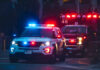 Ambush Rocks Dem Stronghold Police car and ambulance with flashing lights nighttime