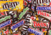 Candy Inflation Surges – Halloween Still Booms Assorted chocolate candy bars and M&M's in colorful wrappers