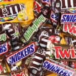Assorted chocolate candy bars and M&M's in colorful wrappers