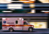 Ambulance driving through city street at speed