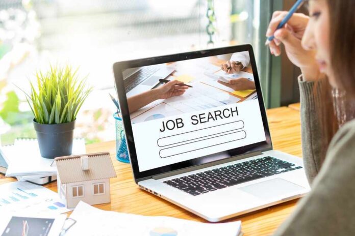 Laptop,With,Job,Search,Engine,On,Screen,In,Modern,Office. Person at desk viewing job search page on laptop