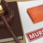 Judge's gavel on a law book beside a stamped document