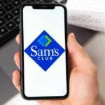 Club Wars Go Turbo: Fresh, Fast, Now A hand holding a smartphone displaying the Sam's Club logo