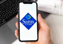 Club Wars Go Turbo: Fresh, Fast, Now A hand holding a smartphone displaying the Sam's Club logo
