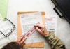 Buried Files Hint At Familiar Names A person in military attire marking a classified document with a red 'FOR SECRET' stamp