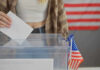 Handwritten Password? Elections On Edge Person casting vote into a ballot box.