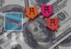 Household Debt SURGES – Trouble Brewing Colorful house icons on a background of hundred dollar bills with a downward trend graph
