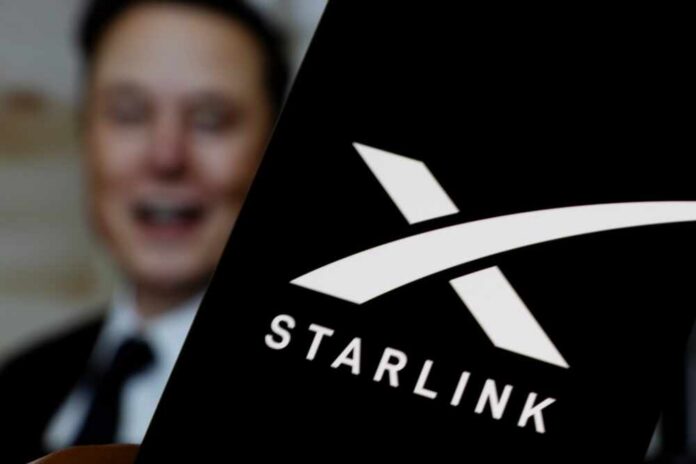 Warsaw,,Poland,-,March,10,,2025:,Elon,Musk,Presents,Starlink Elon Musk behind a phone showing the Starlink logo
