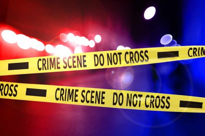 Police,Red,And,Blue,Lights,And,Yellow,Crime,Scene,Do Crime scene tape with police lights in the background