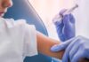 A healthcare professional administering a vaccine to a child's arm