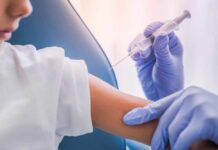 Shingles Plunge Stuns Young Adults A healthcare professional administering a vaccine to a child's arm