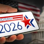 Hand holding a smartphone displaying 'MIDTERM 2026' with a star and American flag in the background